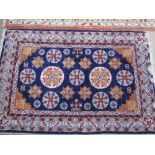 A blue group rug with multiple medallion and flowers