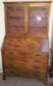 A George III mahogany bureau bookcase, the glazed top with glazing bars,