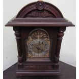 A Kienzle mantle clock, the domed case with a carved cornice and reeded columns,