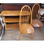 An Ercol three tier shelf unit on wheels together with a pair of Ercol dining chairs