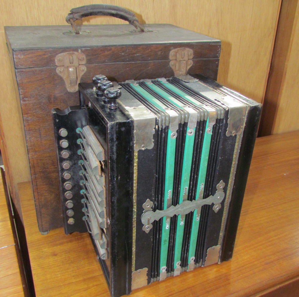 A concertina squeeze box of rectangular form,