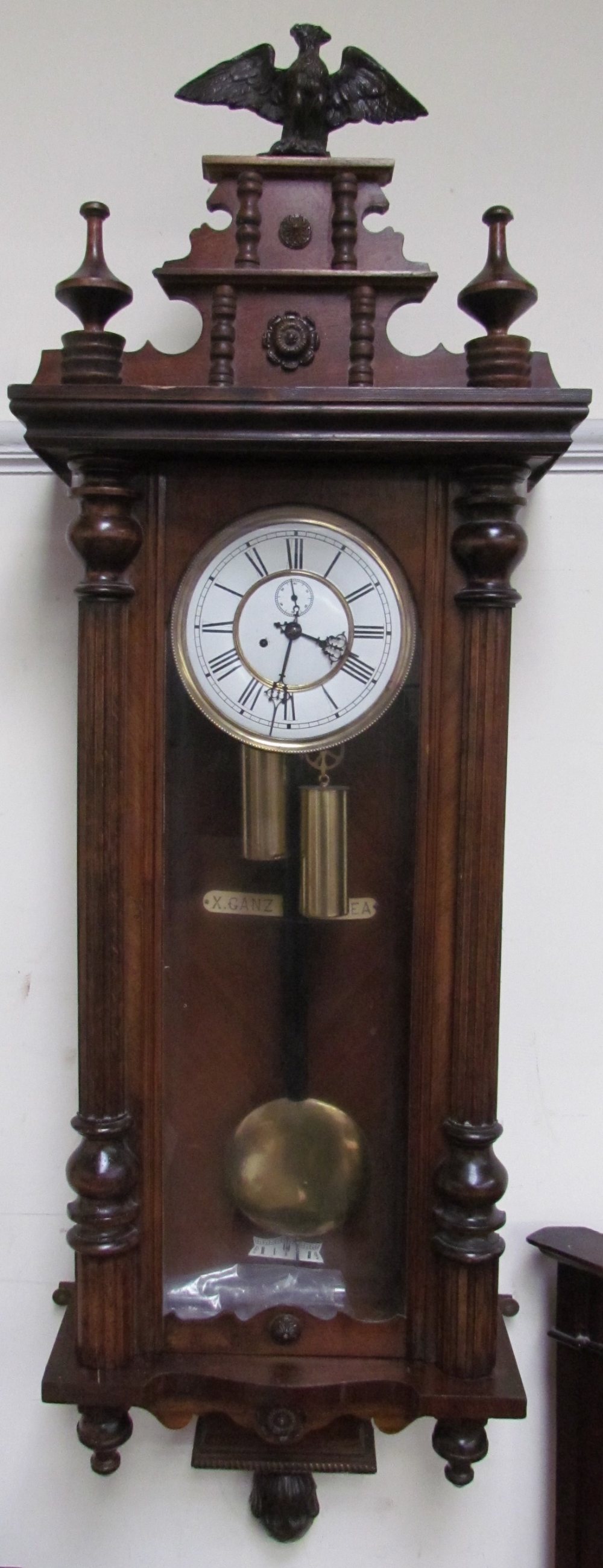 A Vienna regulator type wall clock with eagle cresting and 1/2 columns,