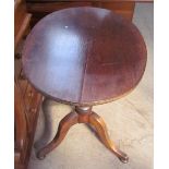 A mahogany tripod table