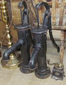Two cast iron water pumps together with a coffee grinder
