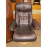 A brown leather reclining armchair