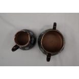 A Doulton Lambeth stoneware cream jug and twin handled sugar basin,