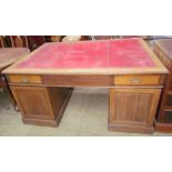 An early 20th century oak partners desk with a leather inset top,