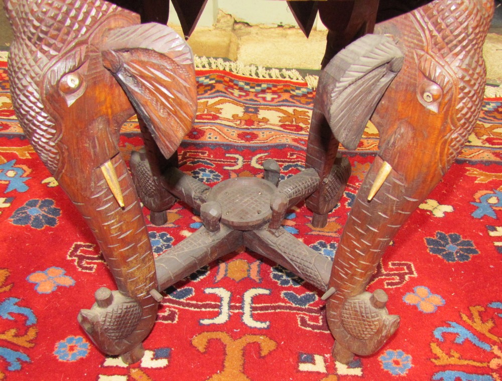 An Indian carved table on elephant head legs, - Image 2 of 2