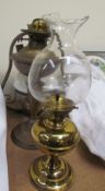 A brass oil lamp together with two other oil lamps