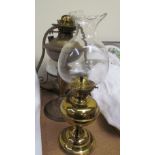 A brass oil lamp together with two other oil lamps