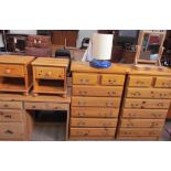 A pair of modern pine chests of drawers together with a pair of pine bedside cabinets, a pine desk,