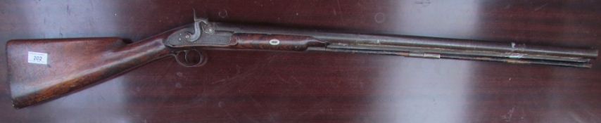 A percussion rifle with a ramrod and figured stock