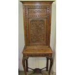 A 19th century oak side cabinet on stand, with carved panel door,