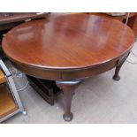 An Edwardian mahogany extending dining table of oval form with cabriole legs and pad feet,