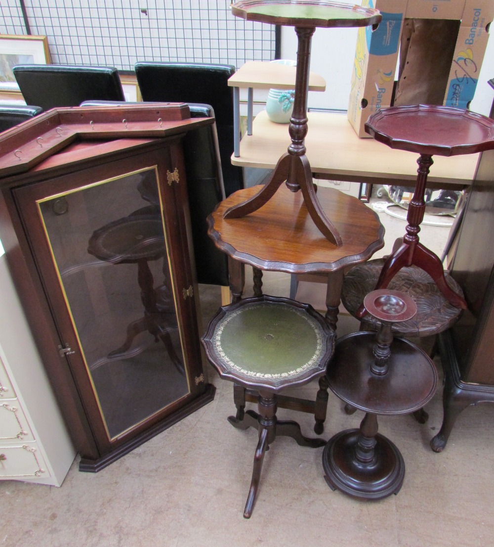 A reproduction mahogany hanging corner cupboard together with reproduction wine tables,