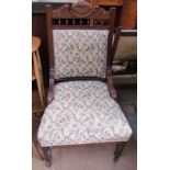 A Edwardian upholstered ladies chair with turned legs and casters together with a tiled top coffee