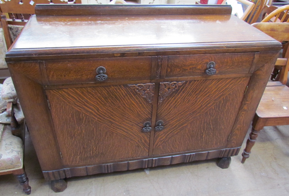 A 20th century oak sideboard with two drawers and two cupboards