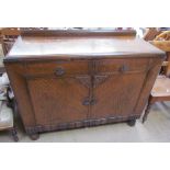 A 20th century oak sideboard with two drawers and two cupboards