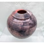 A studio pottery vase in pinks and greys, indistinctly signed,
