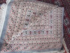 A large blue ground rug with geometric medallions with multiple guard stripes