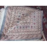 A large blue ground rug with geometric medallions with multiple guard stripes