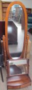 A 20th century beech framed cheval mirror together with a 19th century and later toilet mirror