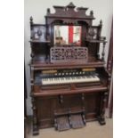 A Mason & Hamlin harmonium, with a central rectangular mirror and shelves