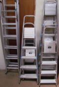 A collection of aluminium ladders, step ladders etc