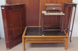 A 20th century mahogany hanging corner cupboard together with a teak coffee table with a smoked