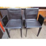 A pair of Italian leather dining chairs by Quia on tapering legs