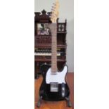A Lindo imitation Fender six string electric guitar on a stand