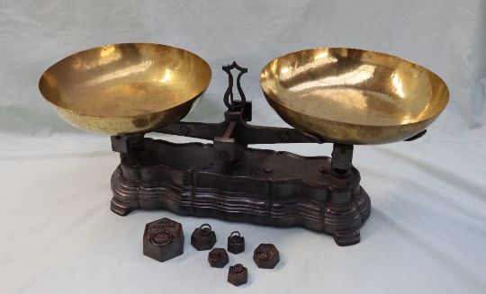 A pair of French brass and cast iron scales, with dished pans, the shaped base cast ''F10K''