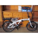 A Harrier Viking Eco-Power folding electric bicycle, in white, together with bicycle helmets