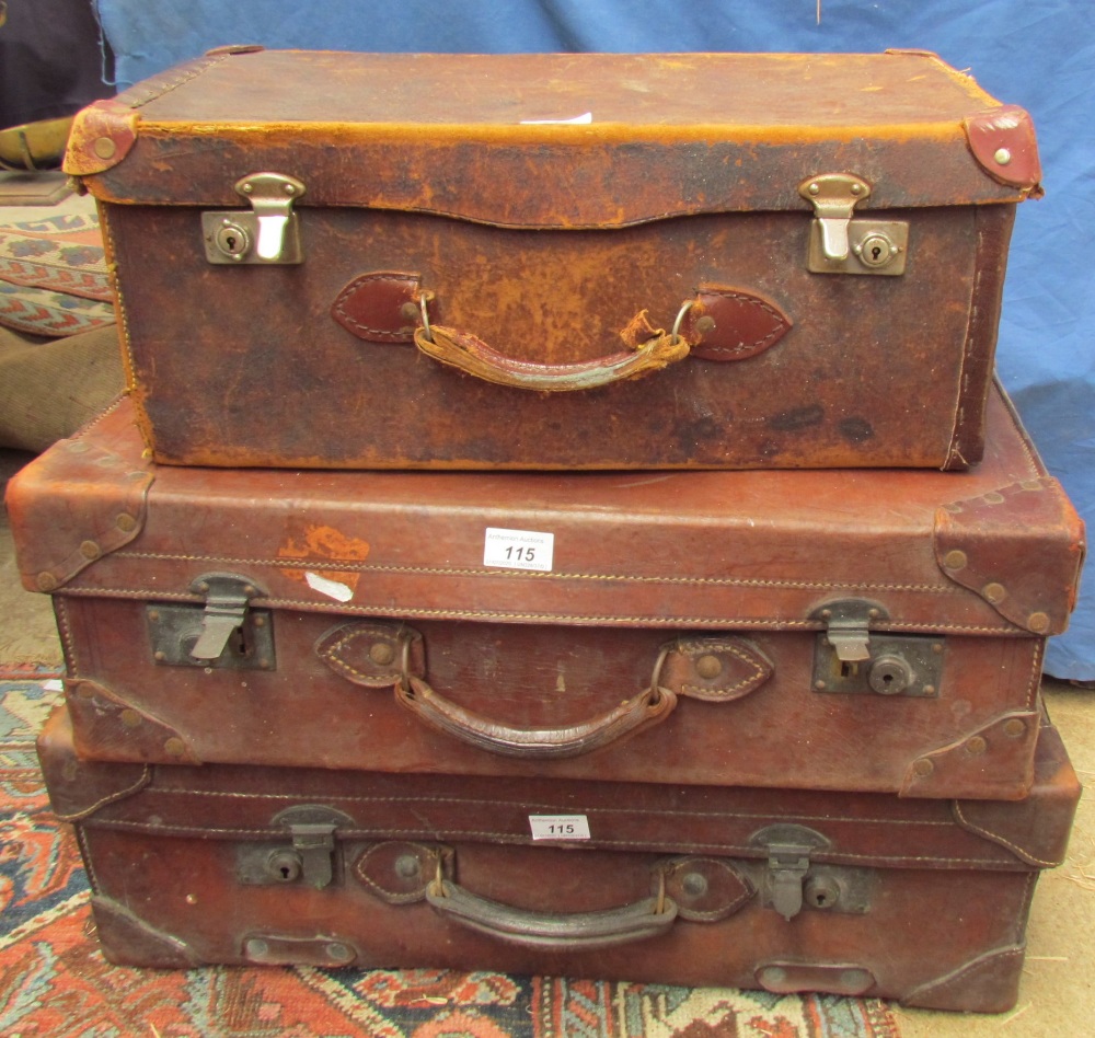 Three leather suitcases of graduating sizes