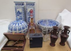 Glass oil lamps together with coloured glass decanters, blue and white vases and bowls, magnifying