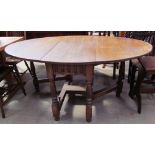 A 20th century oak gate leg table with drop flaps on turned legs