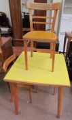 A mid 20th century melamine topped kitchen table together with a set of three chairs