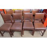 A set of eight oak dining chairs with brown leatherette coverings