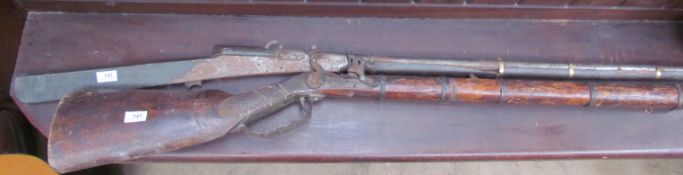 A continental flintlock rifle together with another rifle