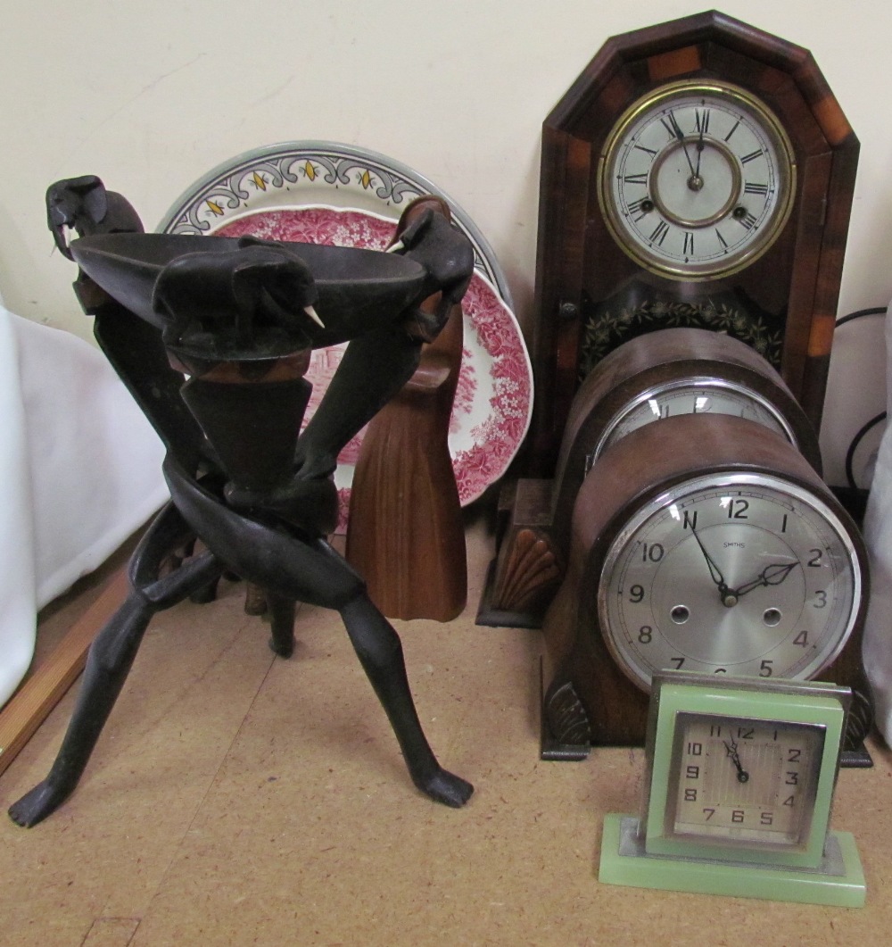 An American walnut mantle clock together with two mid 20th century mantle clocks, carved figures,