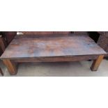 A coffee table with a planked top and square legs, utilising old timbers