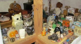 A collection of collectable owls in pottery, glass, wood and other mediums together with