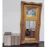 A gilt wall mirror inset with a picture of cats together with assorted folio society books