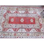 A room size orange ground rug with an orange centre, cream borders and guard stripes