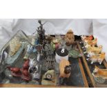 Two ships in bottles together with figures made from nuts and bolts, squirrel nutcracker, cow