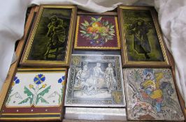 A pair of pottery tiles depicting a young boy holding a lamb and a young girl carrying wood together