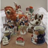 A Staffordshire pottery lion together with Staffordshire figures, toby jugs etc
