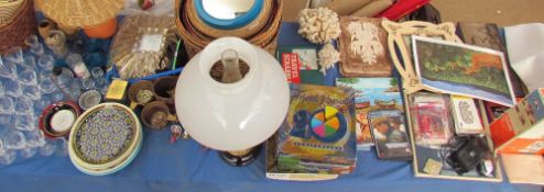 An extensive lot including a brass converted oil lamp, baskets, drinking glasses, pictures,