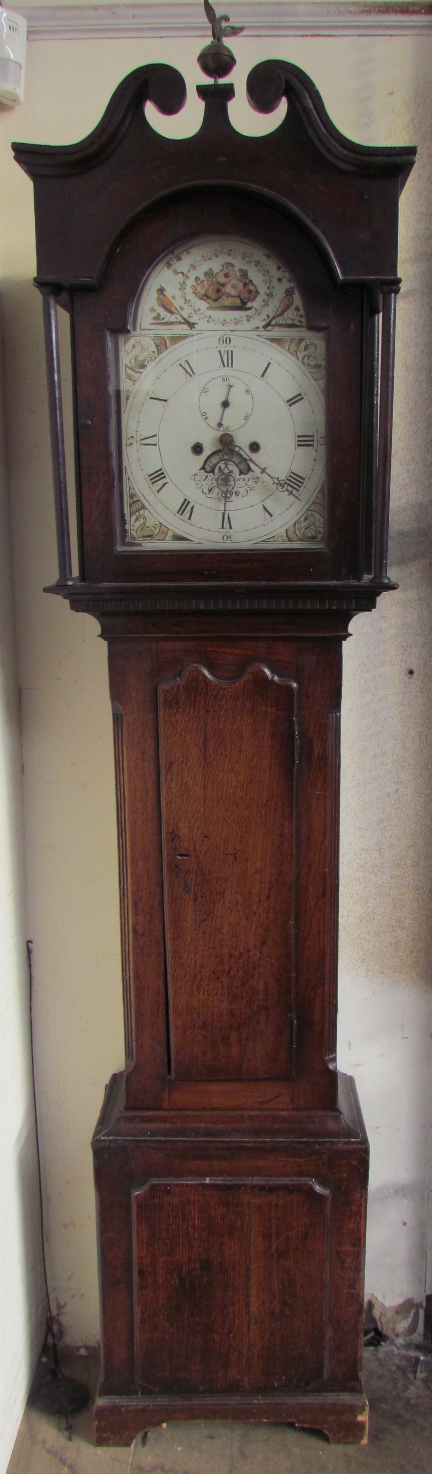 A 19th century oak longcase clock, the hood with a broken swan neck pediment and central globe