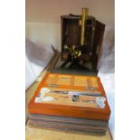 An E G Wood brass monocular microscope, cased together with slides and a Down Brothers medical kit